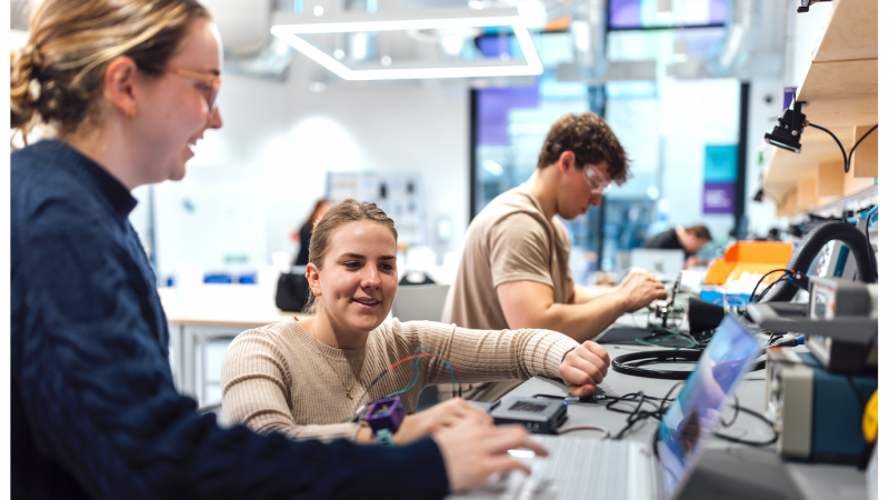 Group of students working in lab with computers