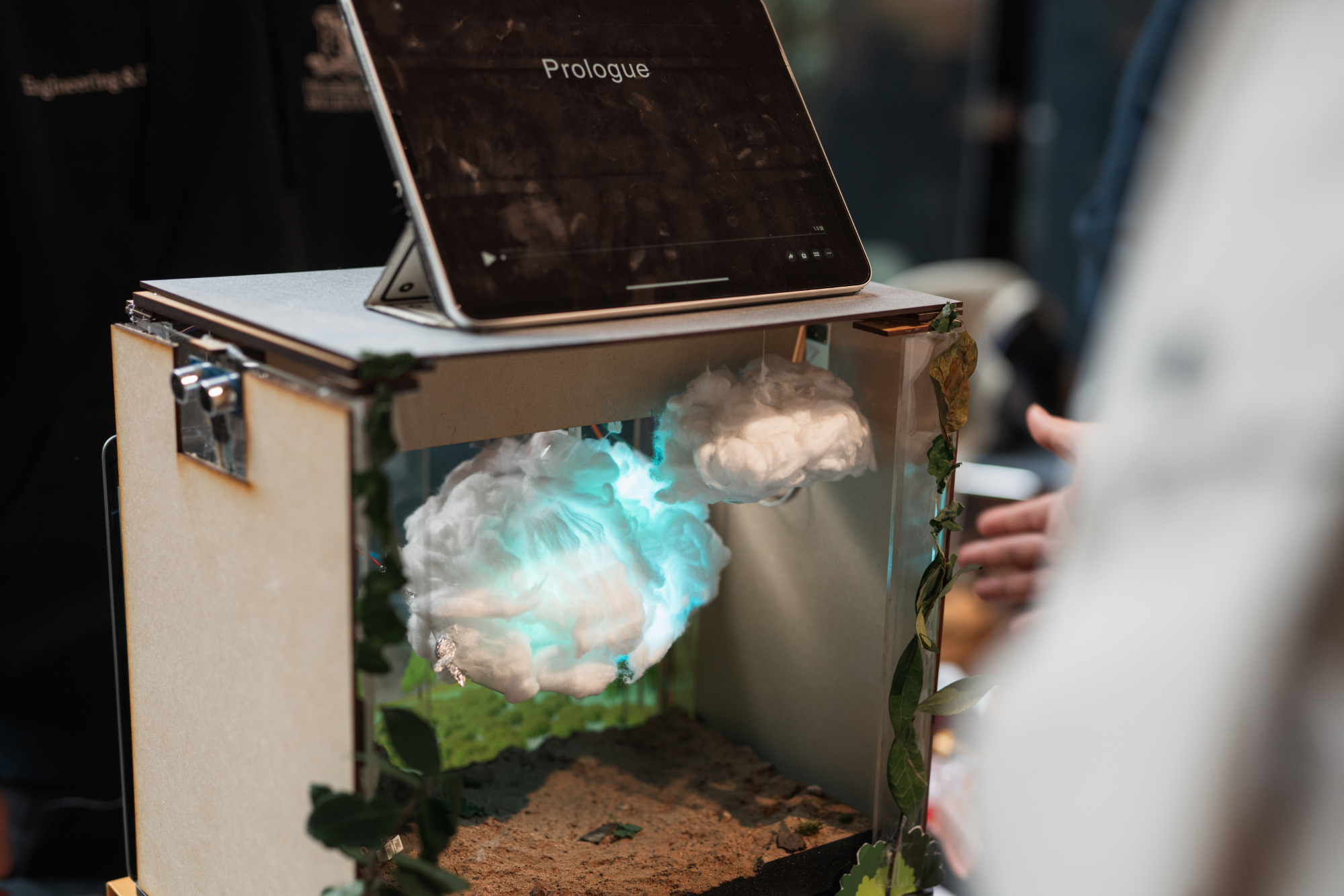 A diorama with clouds made of material and backlit