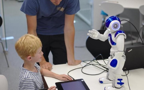 child interacting with robot